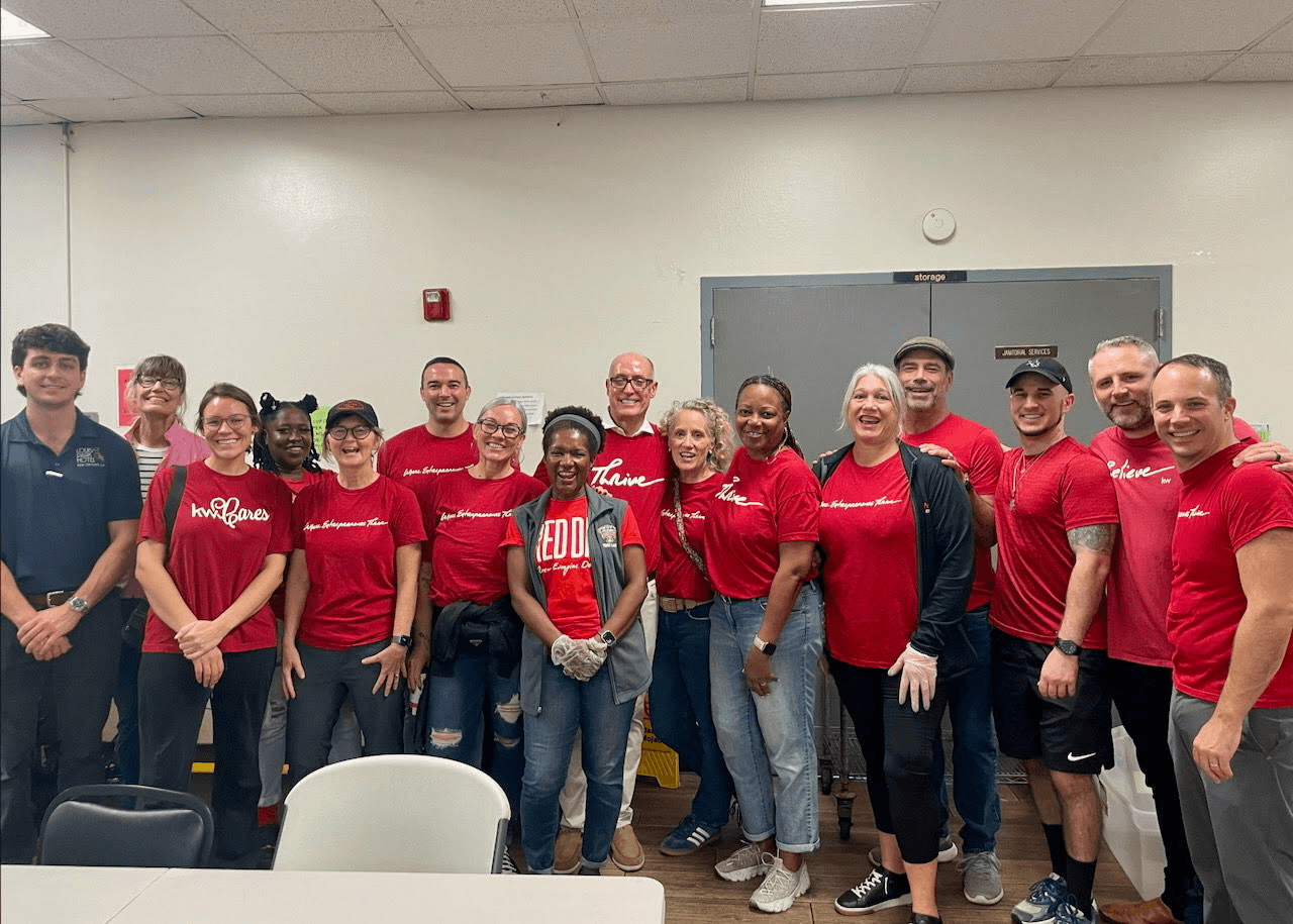 KWNO Shares volunteers in matching red KW Cares shirts at a community service event